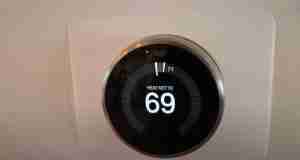 a digital nest thermostat on a wall